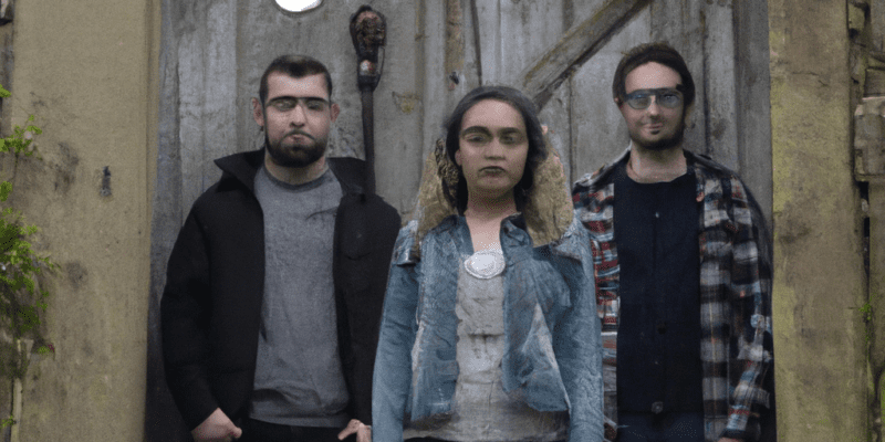 A group of three friends standing in front of an old, mysterious door, looking determined and ready for adventure.