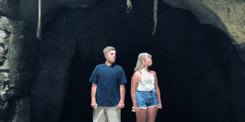 A picture of Sarah and Tyler standing in front of a mysterious cave entrance.