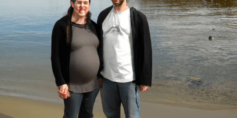 Image prompt: A picture of Sarah and Alex standing on the shore of a river, with a baby seal in the water behind them.